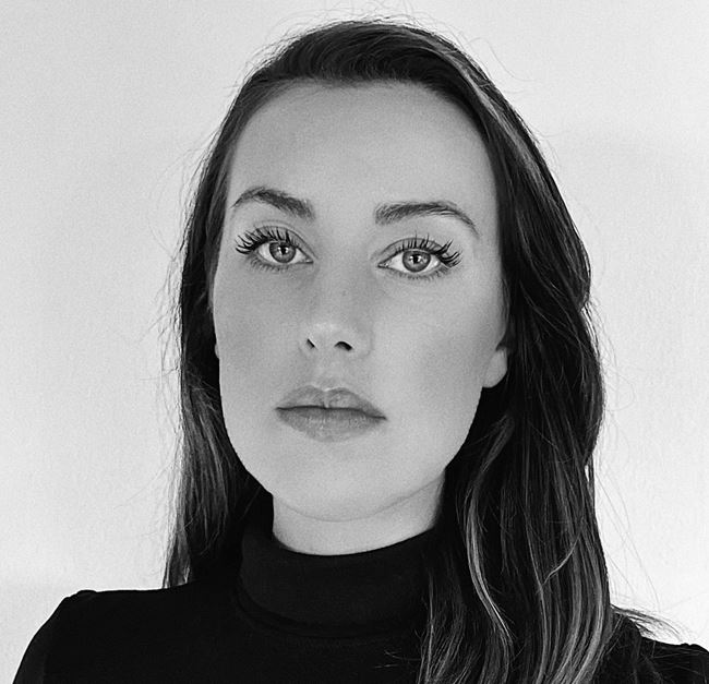 a woman with long hair and a black turtleneck