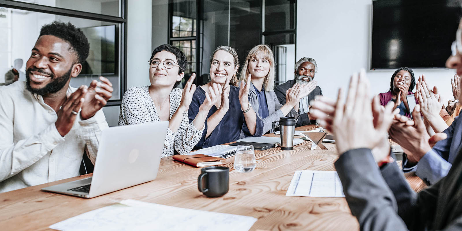 a group of people clapping at a table