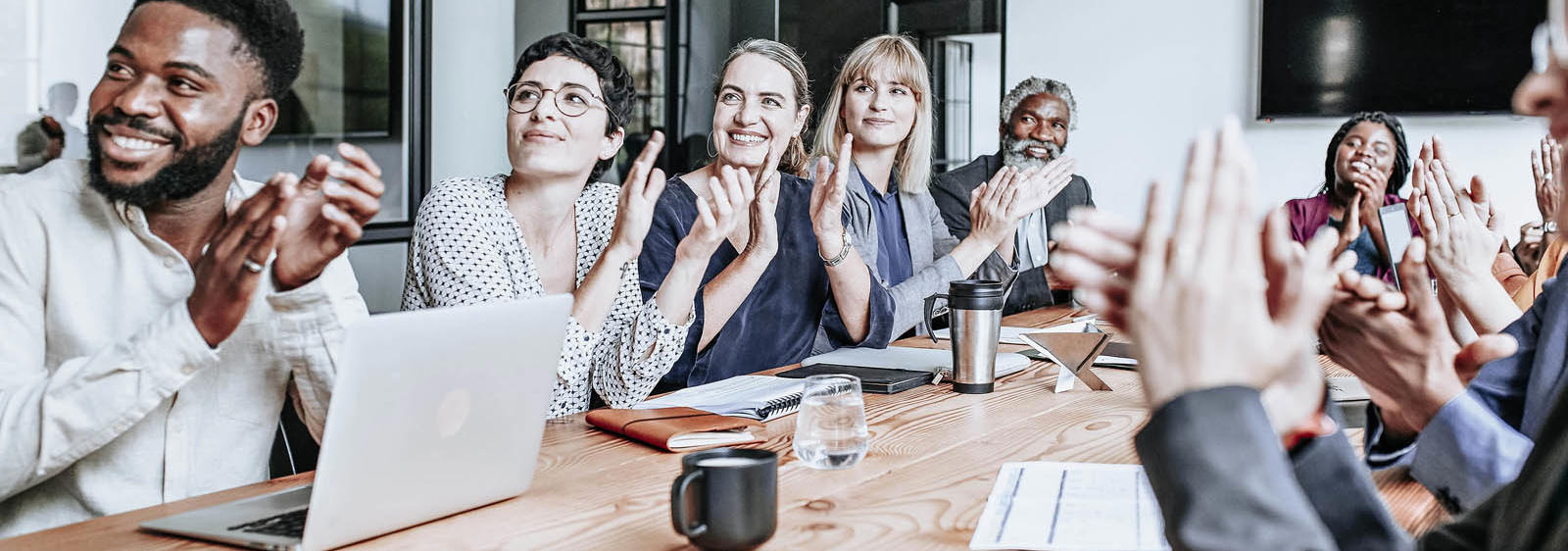 a group of people clapping at a table