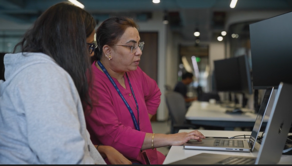 a woman sitting at a desk with a laptop