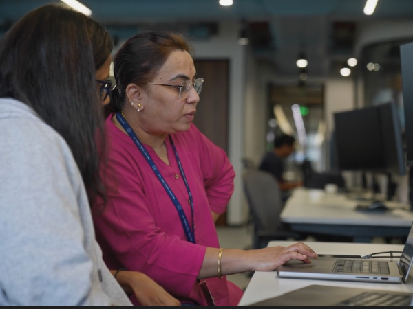 a woman sitting at a desk with a laptop