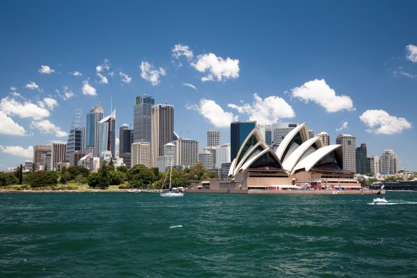 a city skyline with a boat in the water