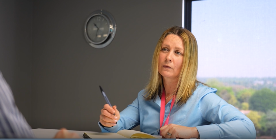 a woman holding a pen