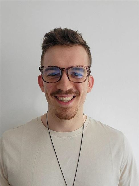 a man wearing glasses and a white shirt
