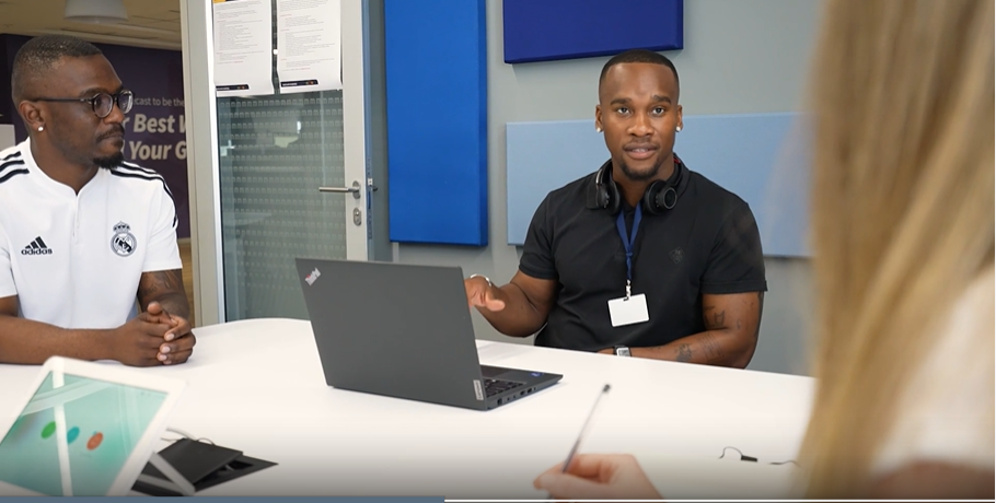 a man sitting at a table with a laptop