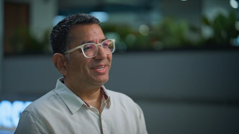 a man wearing glasses and smiling