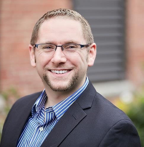 a man wearing glasses and a suit