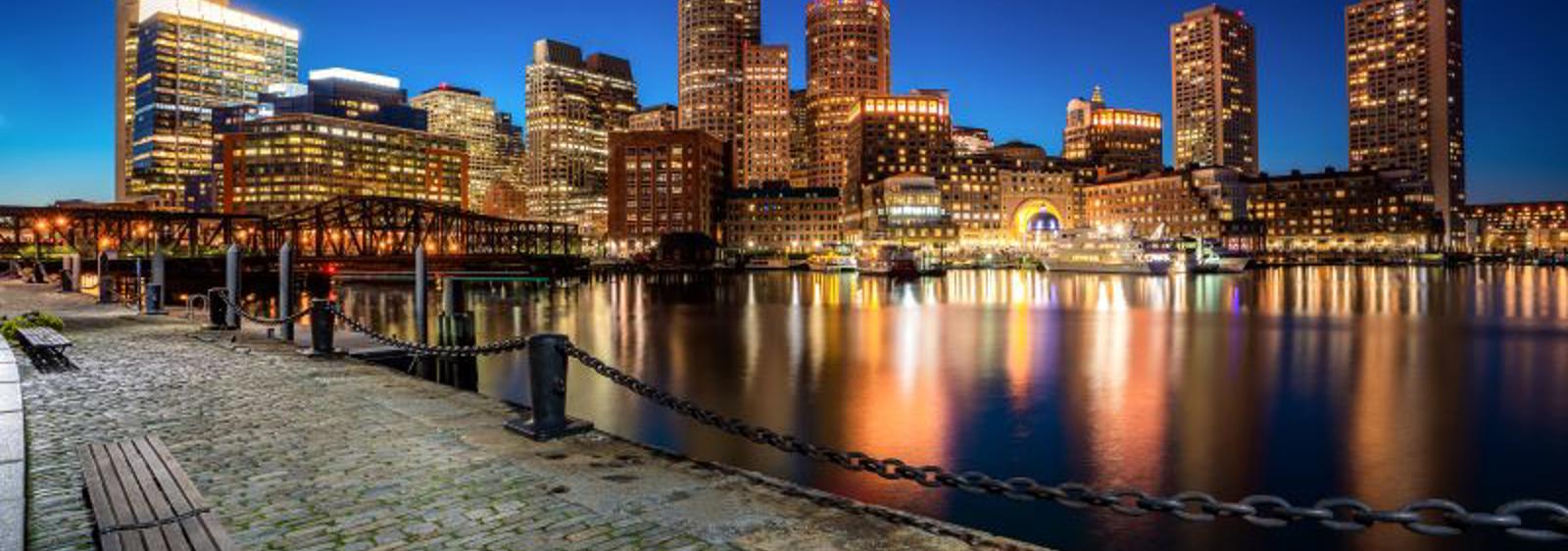 a city skyline with lights reflecting on water