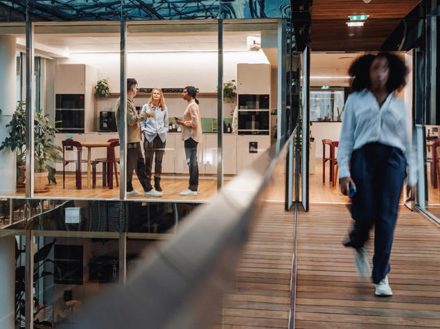 a group of people walking in a room